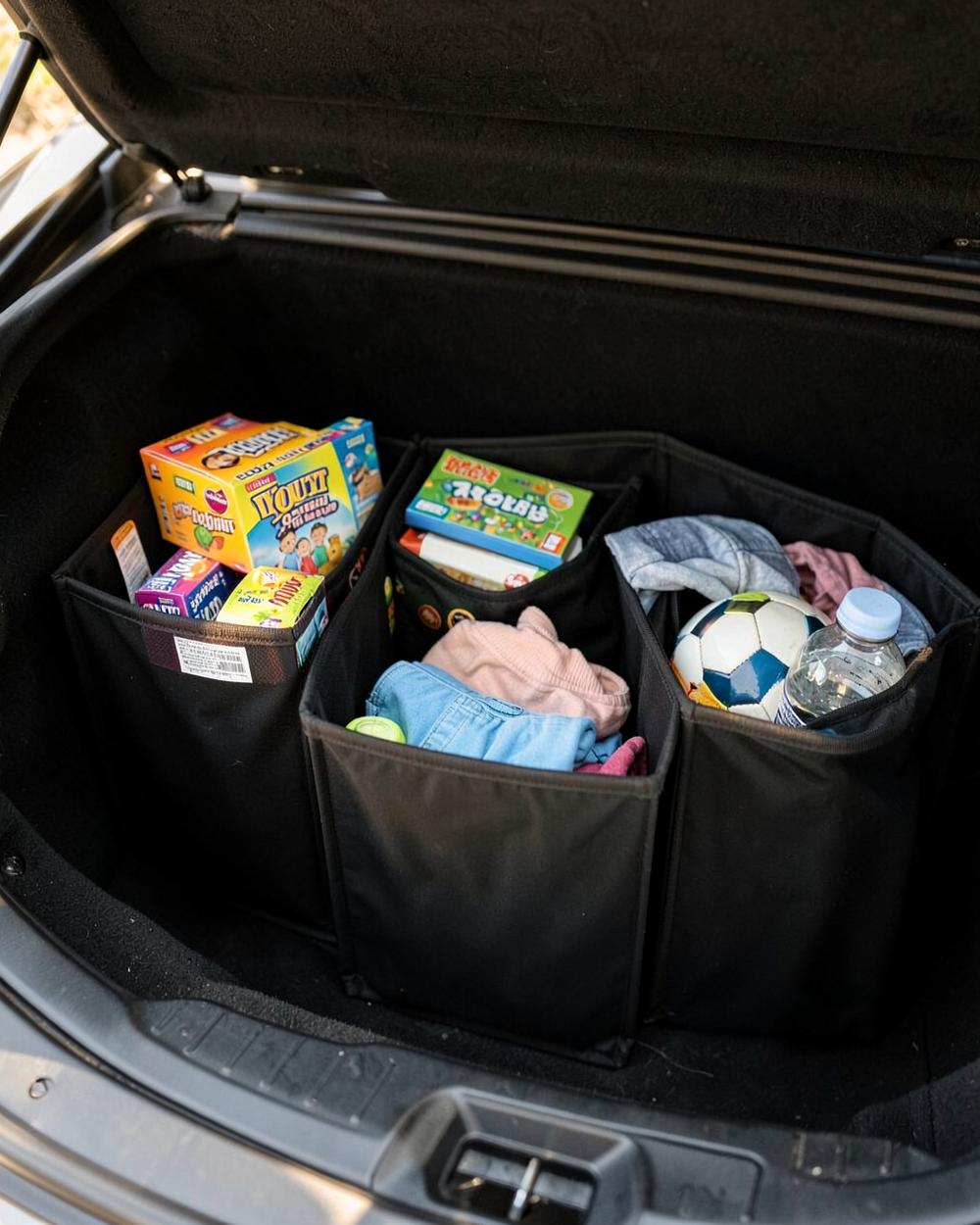 STOWVELA. Trunk Organizer holding snacks, games, and extra layers for kids